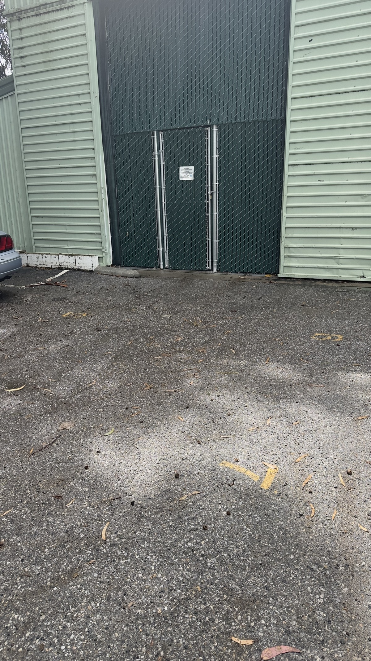 Locked gate at the Geng safe-parking site during mild rain