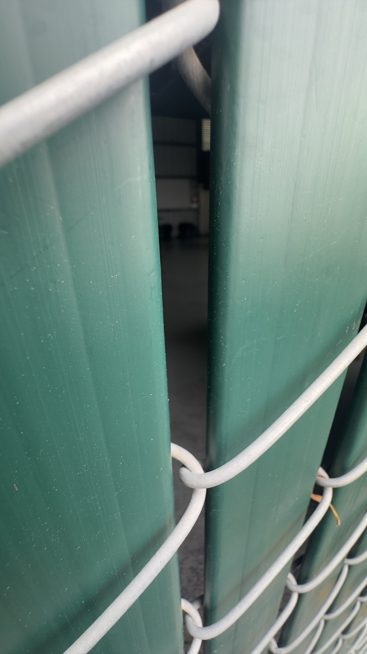 Close view through fencing toward an interior area at the Geng safe-parking site