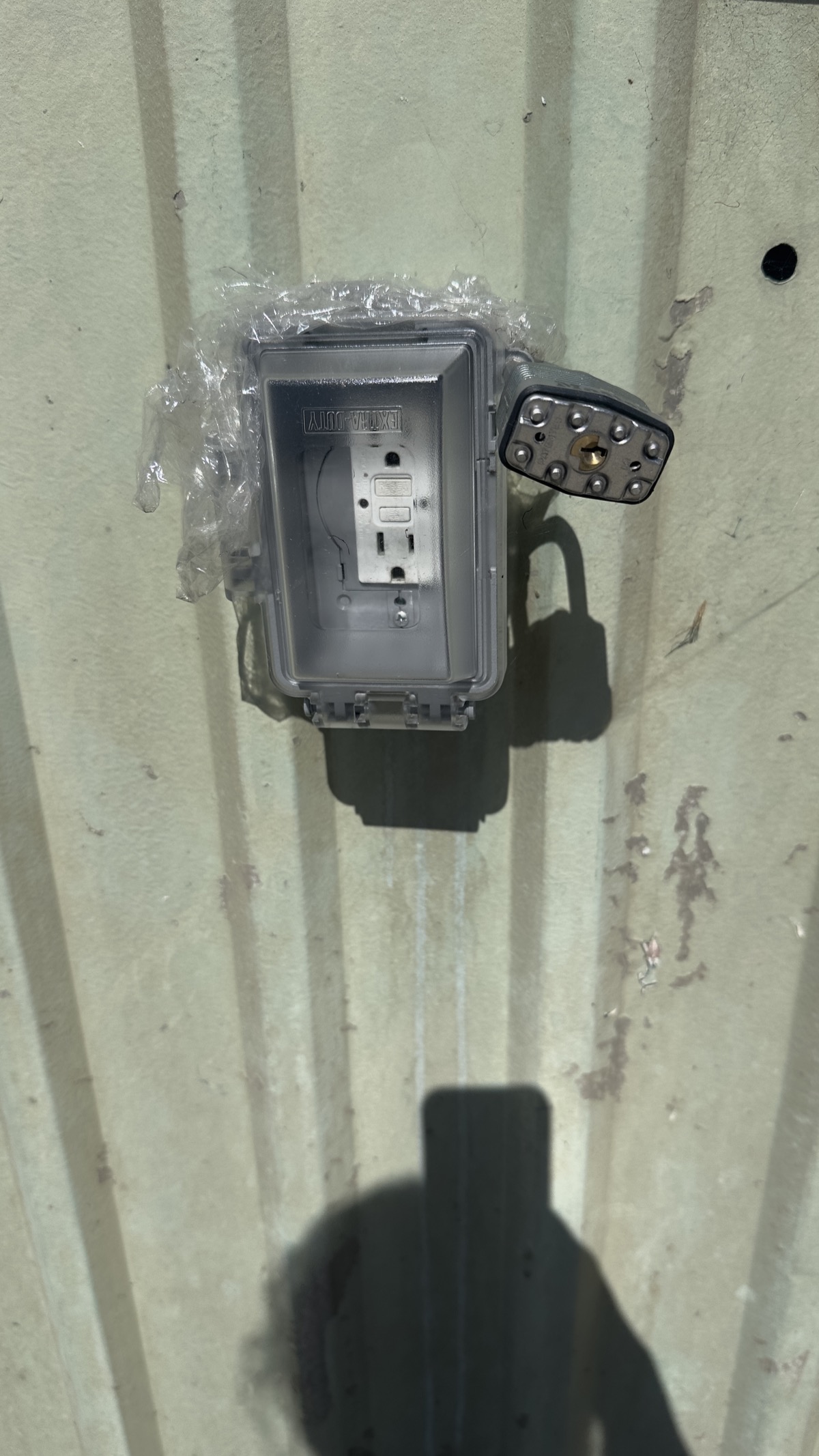 Locked exterior wall outlet at the Geng safe-parking site on May 13, 2026